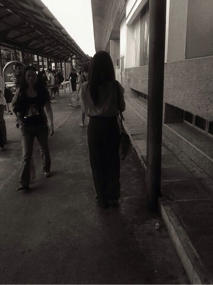 WOMAN STANDING ON FOOTBRIDGE