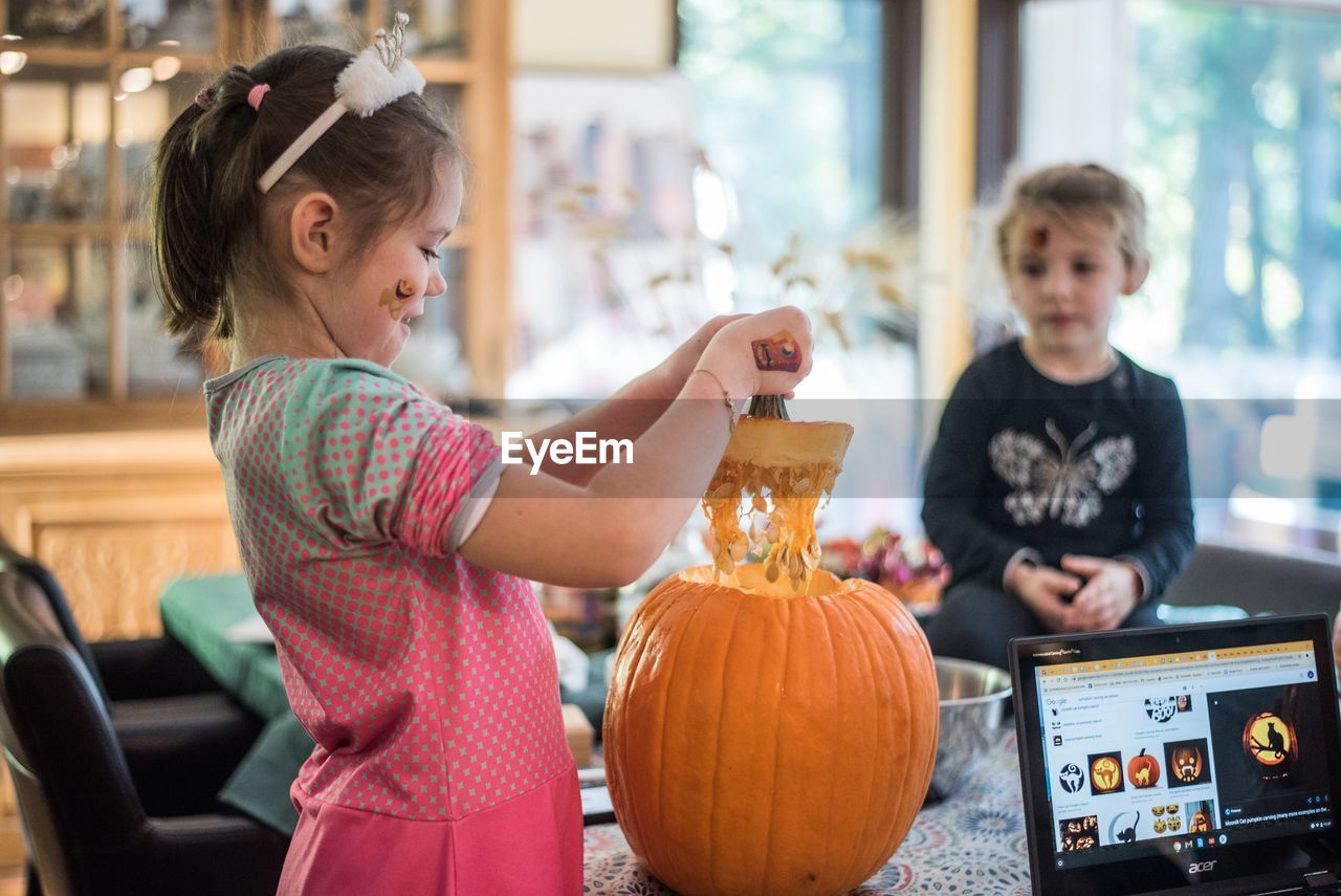 CUTE BOY HOLDING PUMPKIN AT HALLOWEEN