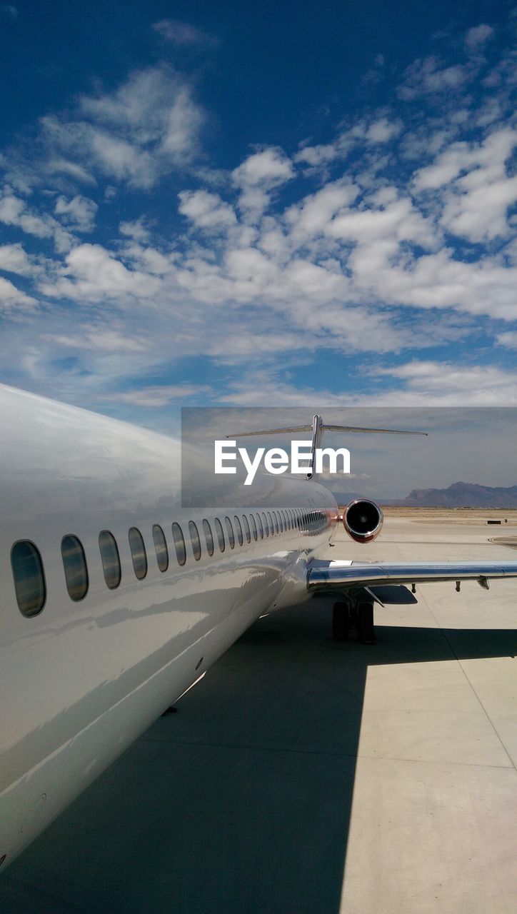 Close-up of airplane on airport against sky