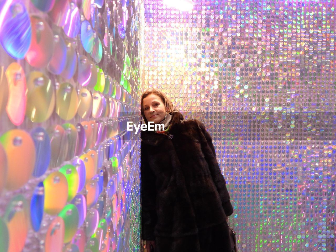 Portrait of young woman standing in store