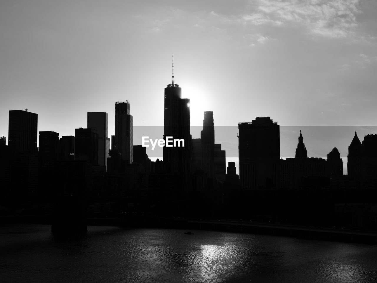 View of city at waterfront during sunset