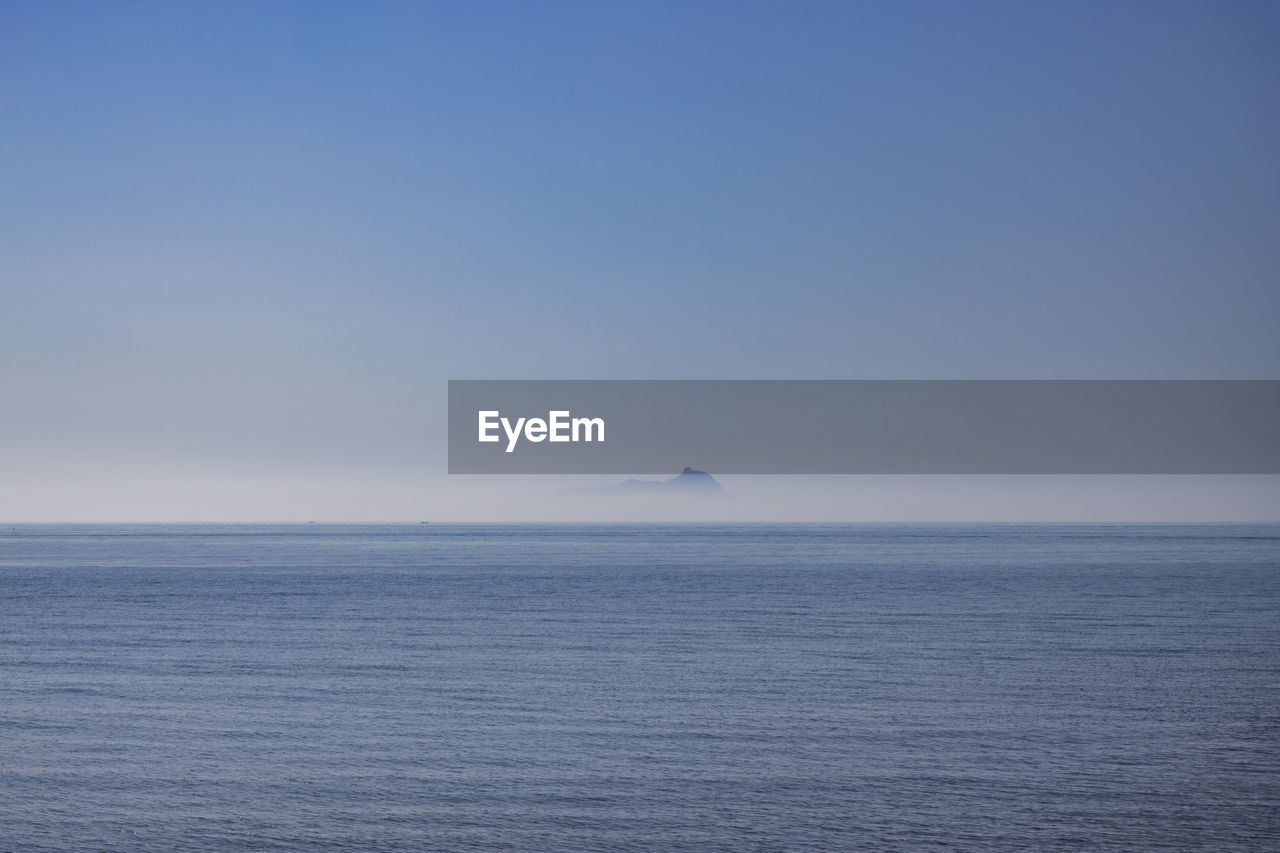 horizon, sea, water, sky, ocean, beauty in nature, scenics - nature, horizon over water, blue, tranquility, nature, tranquil scene, no people, copy space, coast, seascape, cloud, environment, clear sky, travel, outdoors, idyllic, wave, day, vehicle, shore, urban skyline, travel destinations, distant, non-urban scene, transportation, landscape