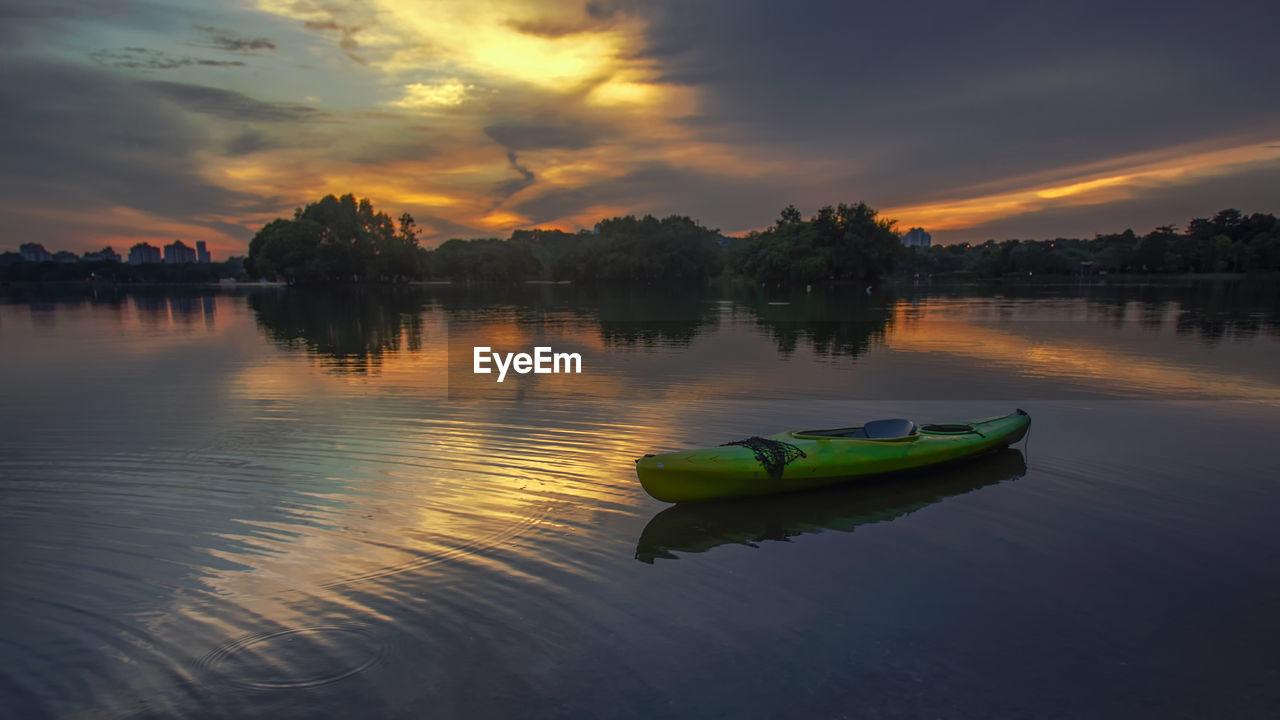 Scenic view of river against sky at sunset