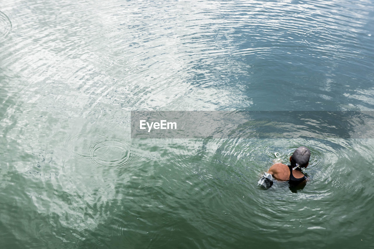 High angle view of man swimming in sea