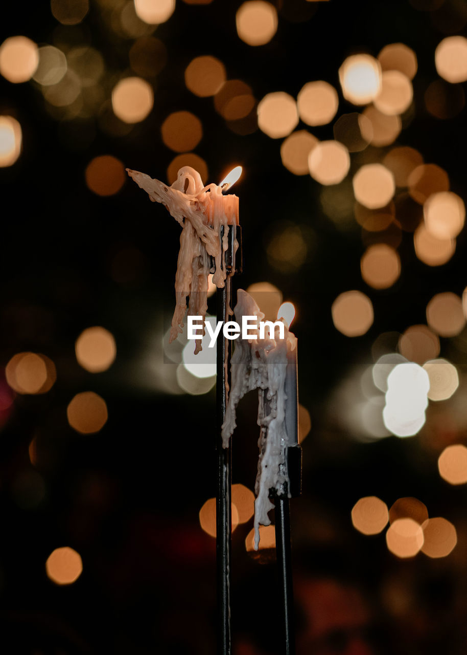 Close-up of lit candles at night during christmas