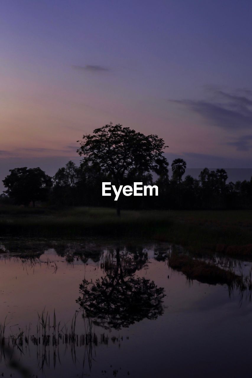 SCENIC VIEW OF LAKE AT SUNSET