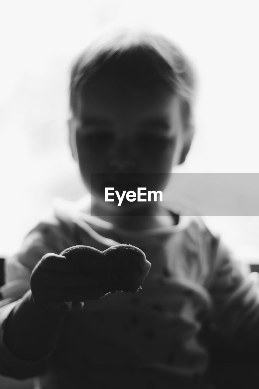 CLOSE-UP OF BOY HOLDING ICE