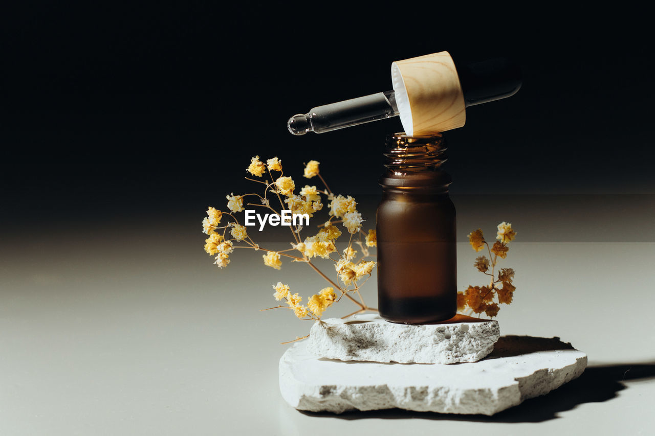 Amber bottle with serum or essential oil. natural organic cosmetic, aromatherapy message oil.