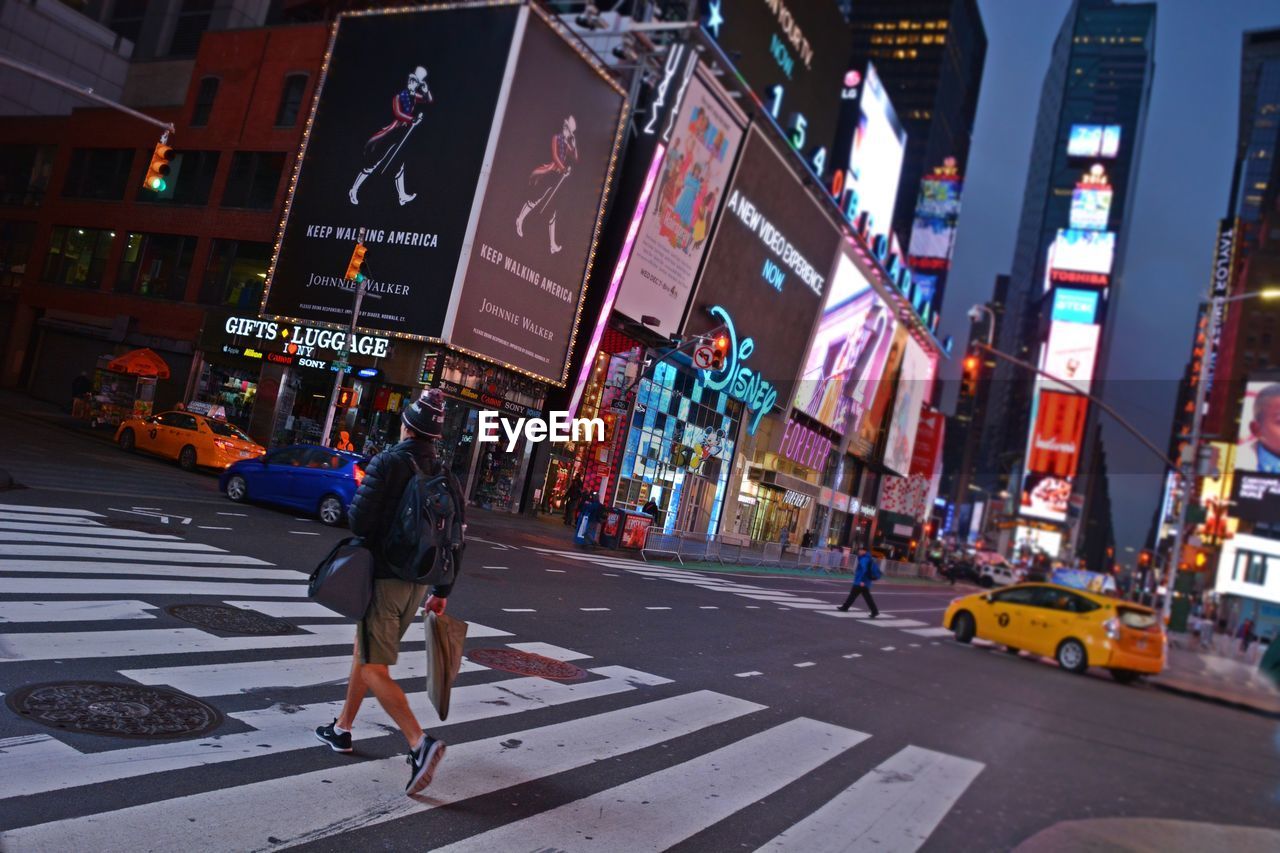 PEOPLE CROSSING ROAD IN CITY