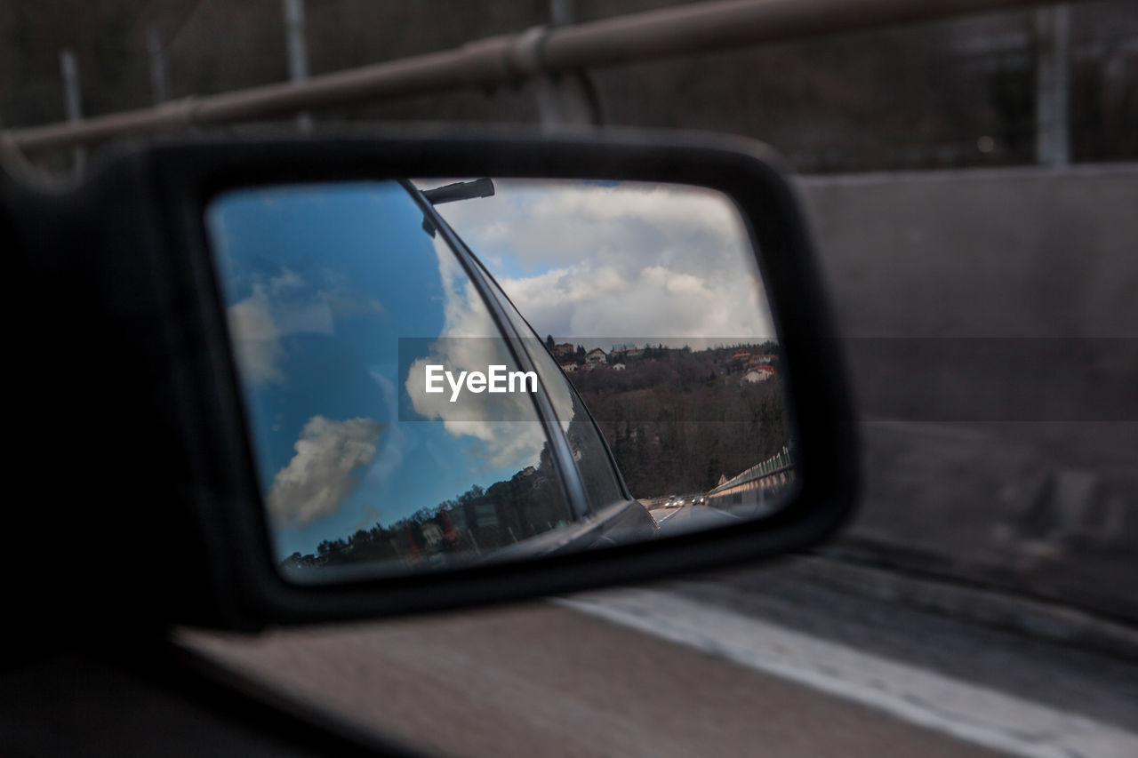 Reflection of car window on side-view mirror