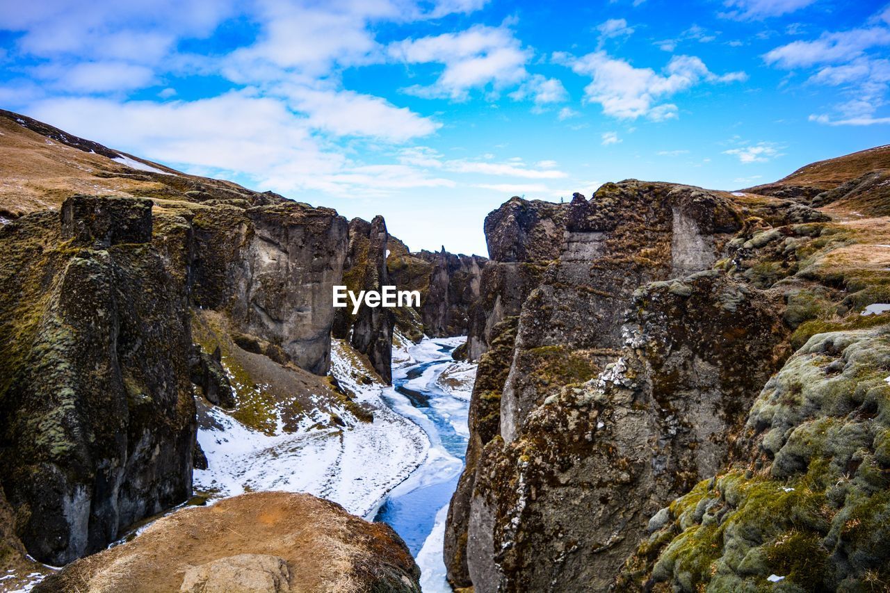 Panoramic view of rocks in mountains against sky