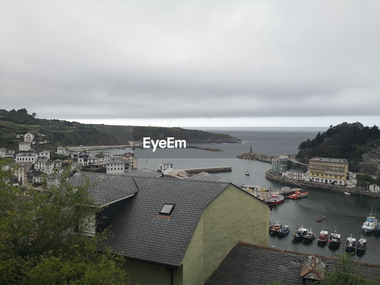 High angle view of townscape by sea against sky