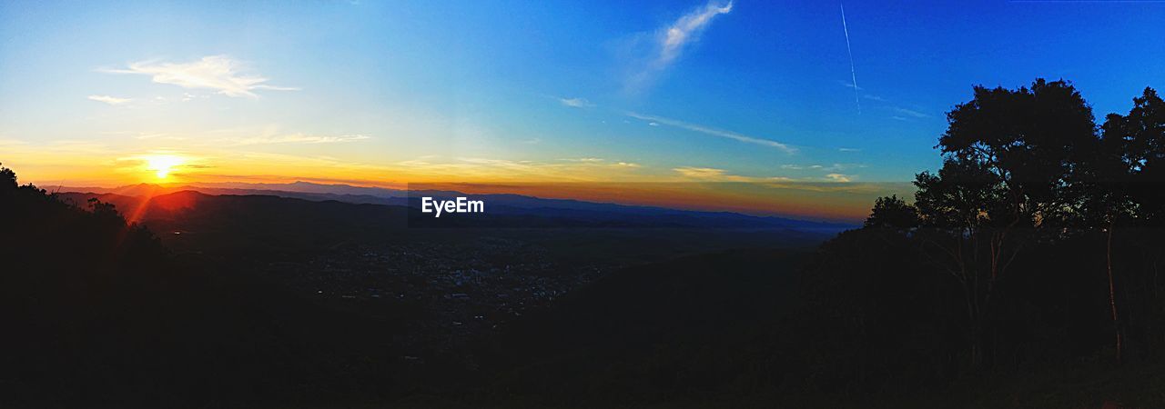 SCENIC VIEW OF SILHOUETTE LANDSCAPE AGAINST SKY AT SUNSET