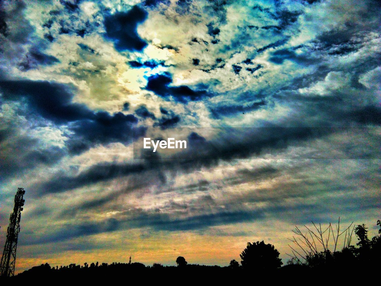 LOW ANGLE VIEW OF DRAMATIC SKY OVER SILHOUETTE TREES