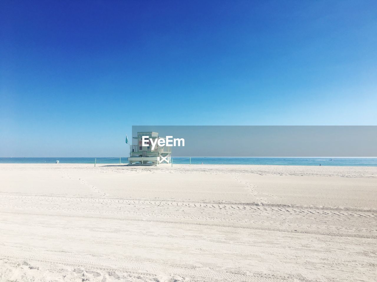 VIEW OF BEACH AGAINST CLEAR BLUE SKY