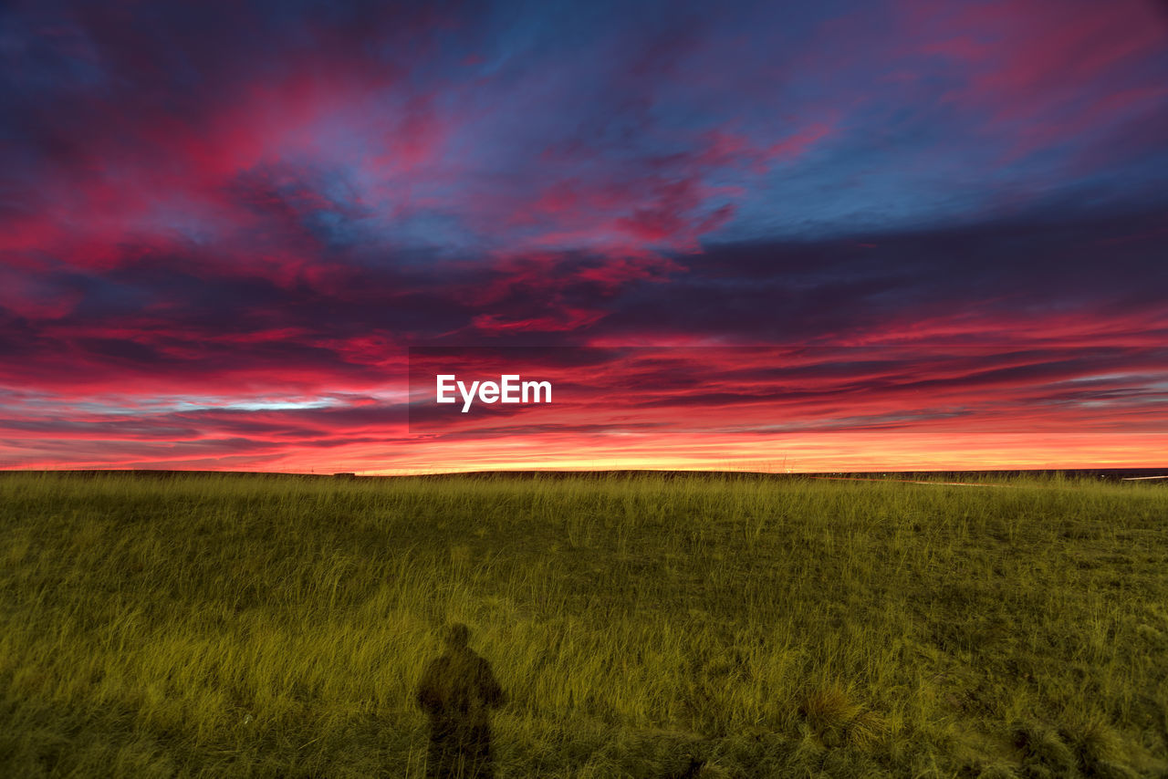 Scenic view of landscape against dramatic sky