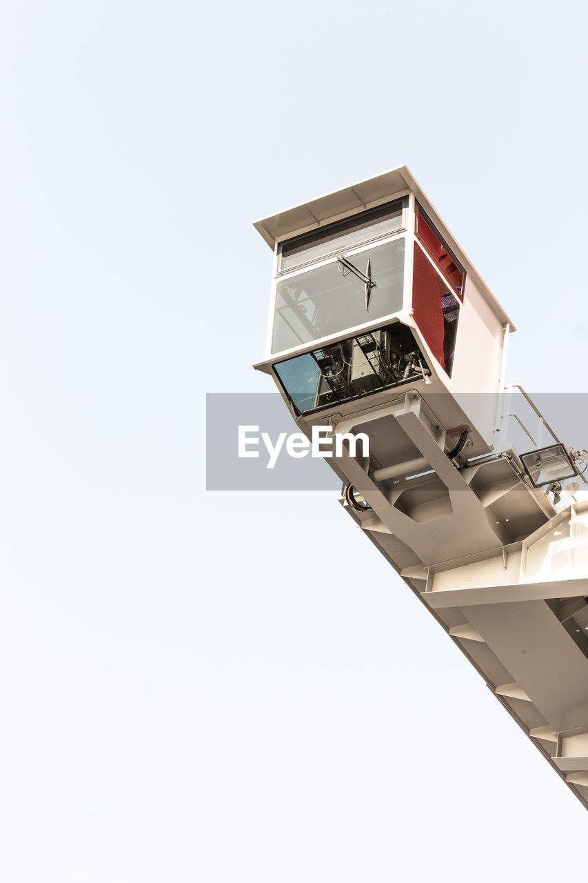 Low angle view of crane against clear sky