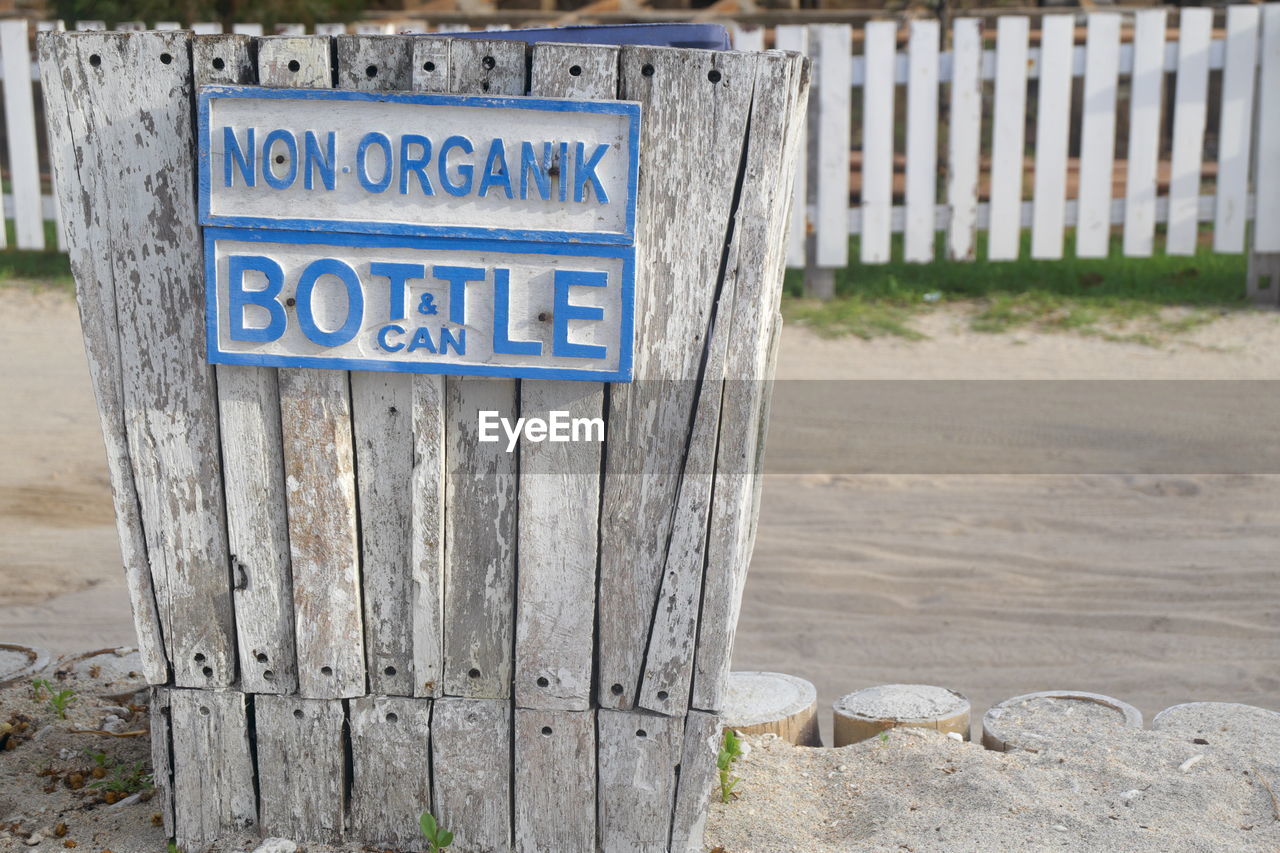 CLOSE-UP OF WOODEN SIGN