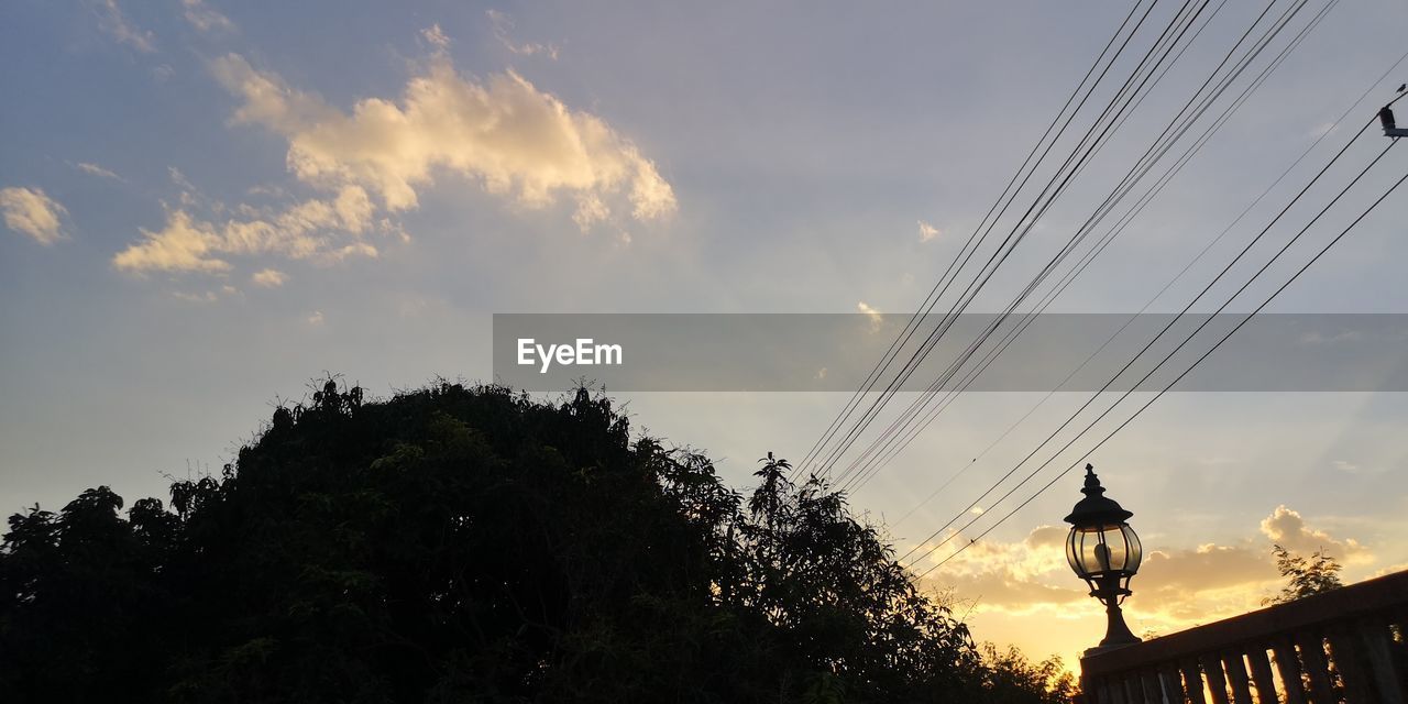 sky, evening, cloud, architecture, dusk, nature, cable, sunset, tree, electricity, sunlight, built structure, low angle view, silhouette, plant, technology, no people, street light, building exterior, light, lighting equipment, outdoors, city, street, power line, travel destinations