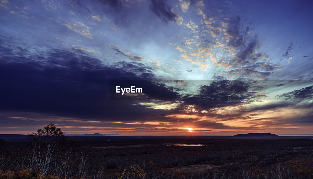 SCENIC VIEW OF SUNSET OVER LAND