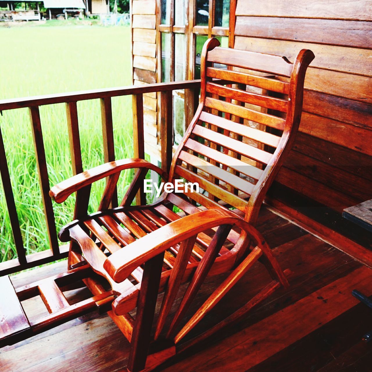 EMPTY CHAIRS AND TABLES IN THE PORCH