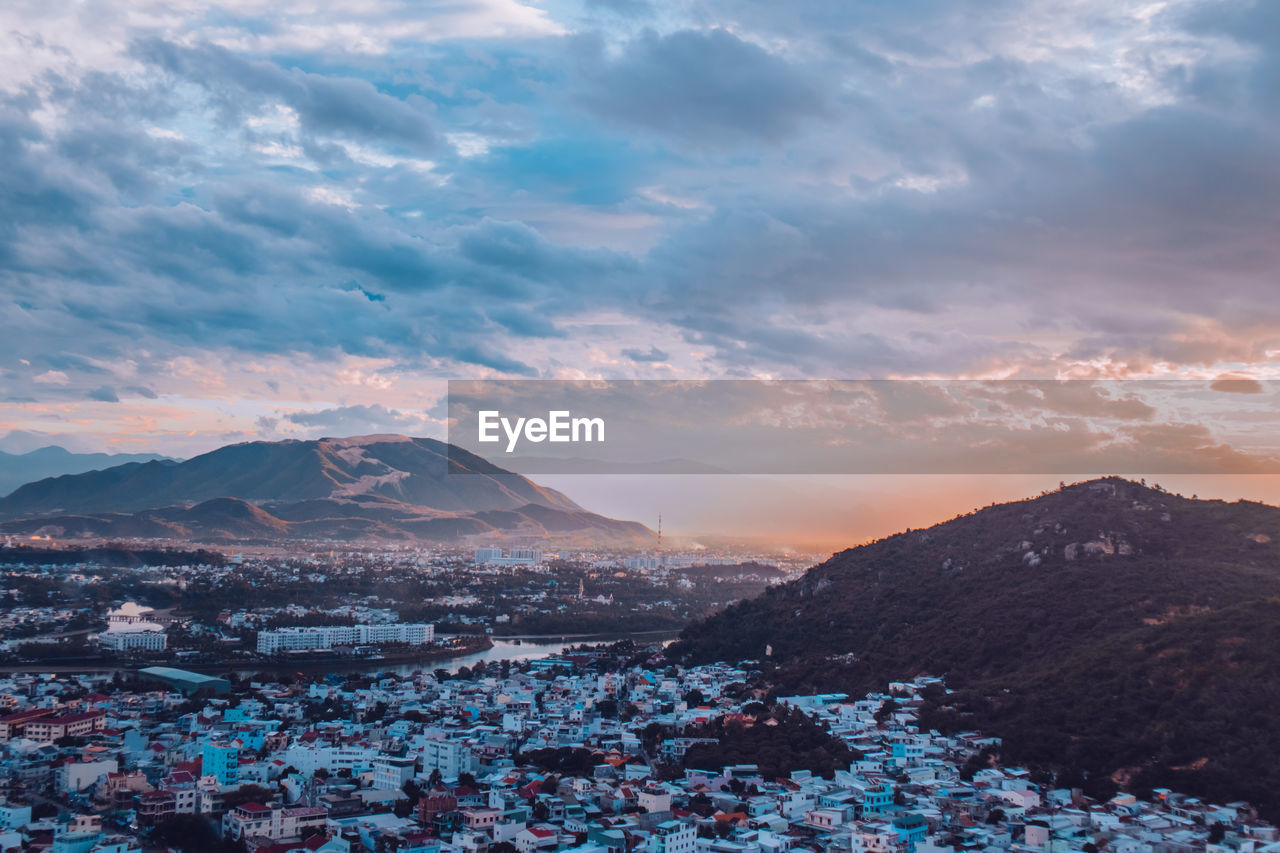 Aerial view of townscape against sky during sunset