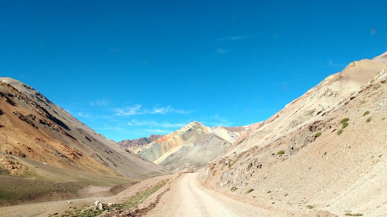 Scenic view of mountains against clear blue sky