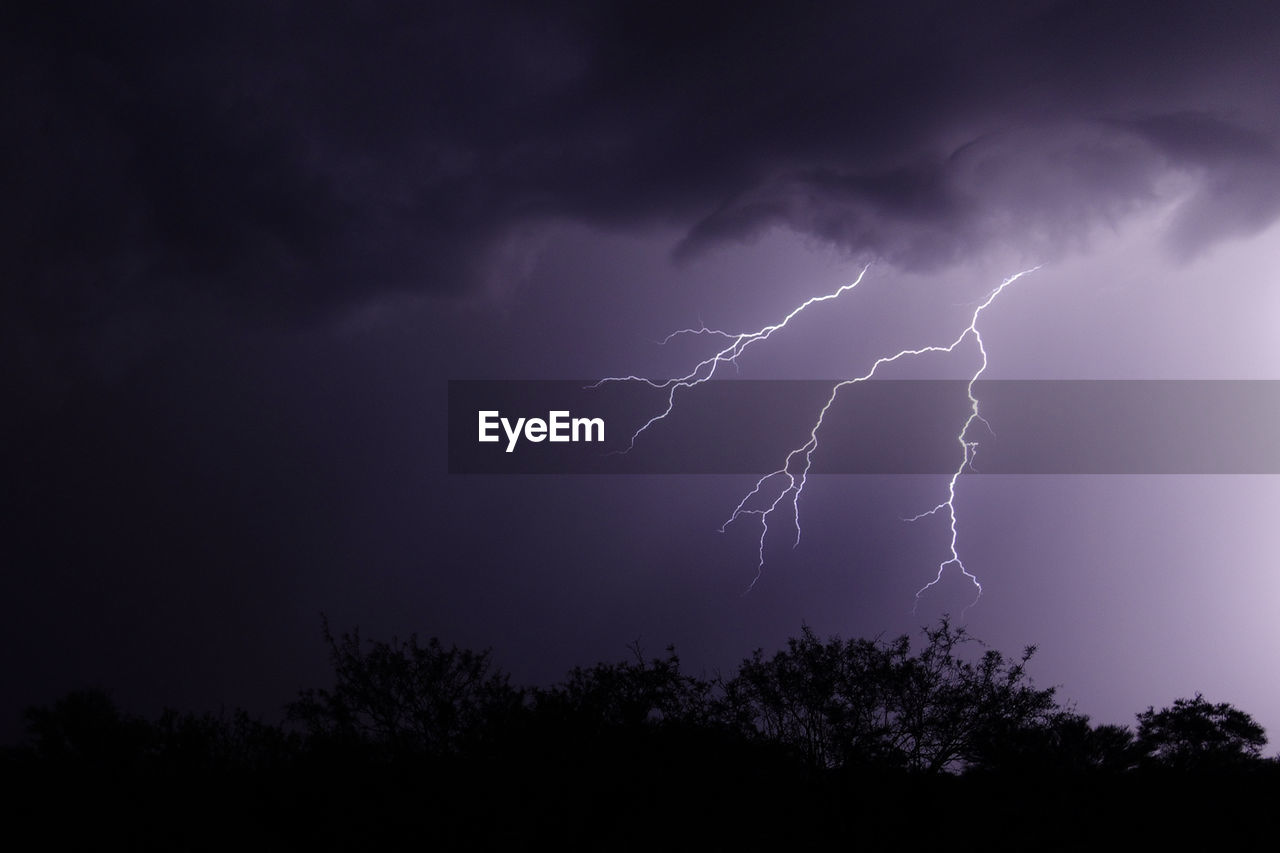 Lightning and dark, moody clouds over the desert during monsoon storm