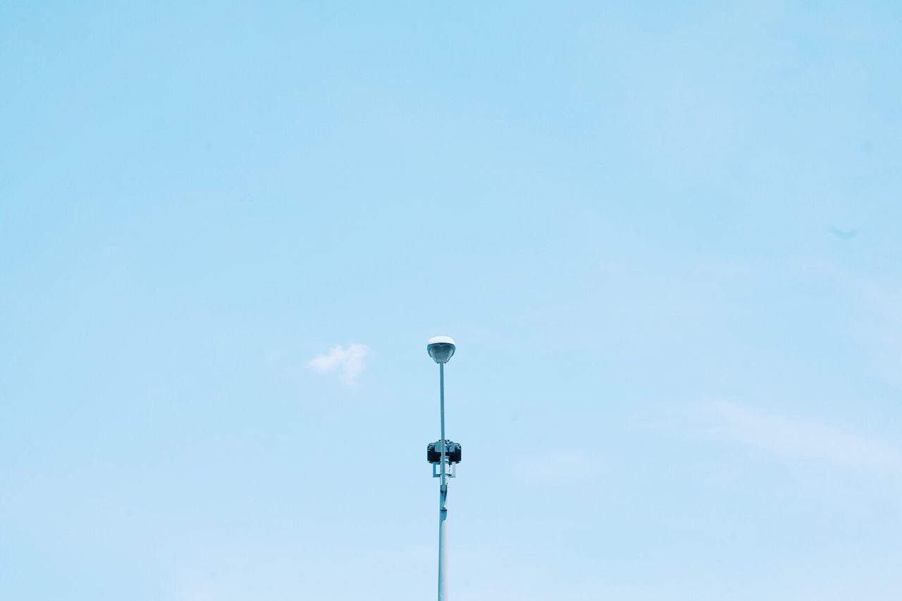 Low angle view of street light against blue sky