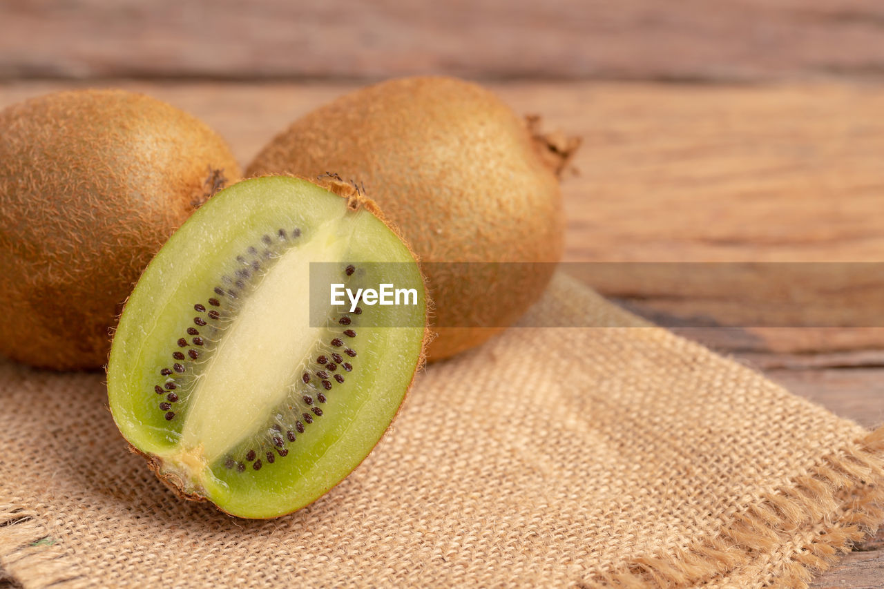 A half of kiwis slice placed on the brown sack.