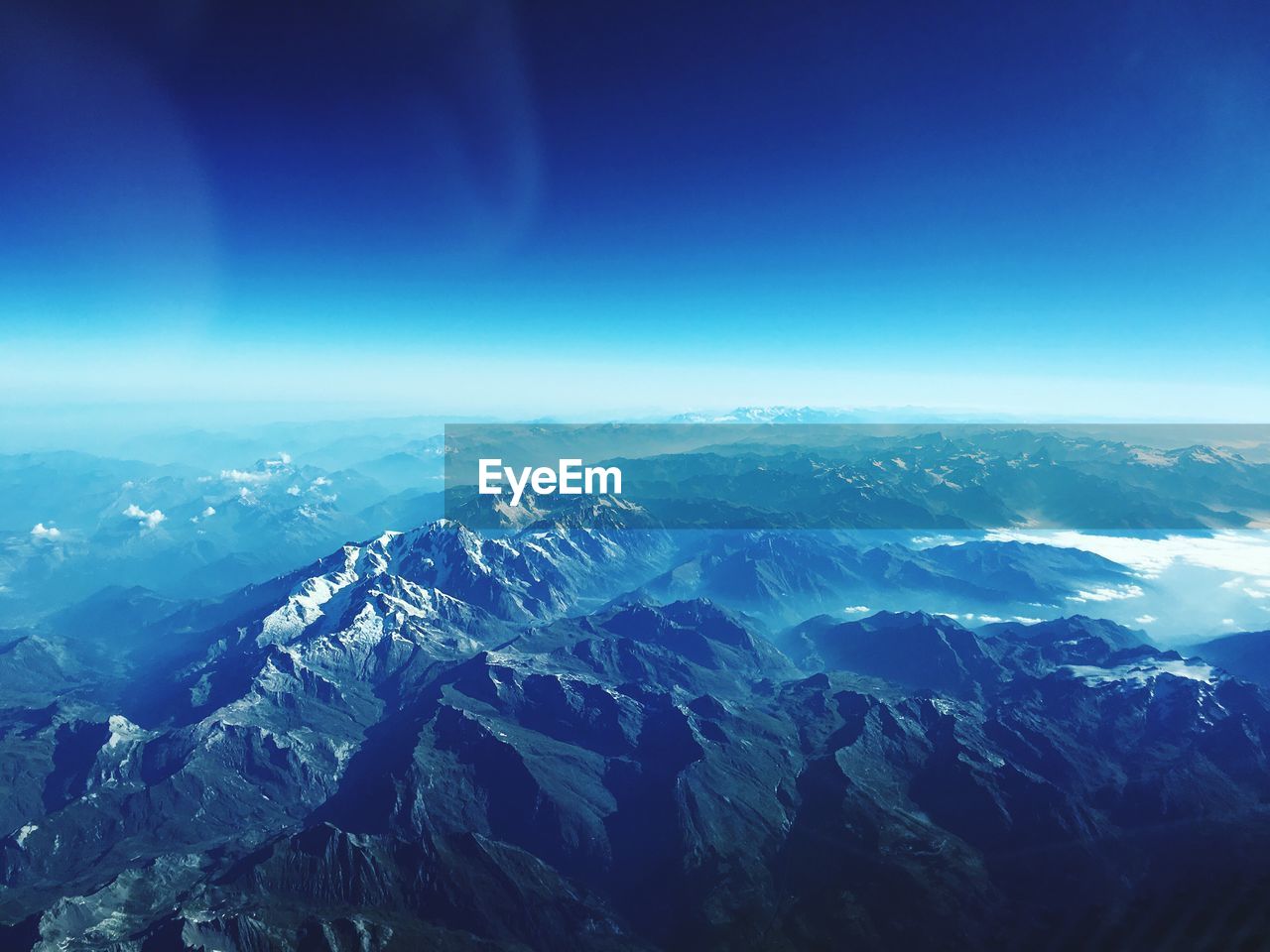 Aerial view of dramatic landscape against blue sky