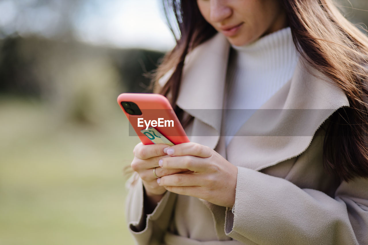 WOMAN USING MOBILE PHONE