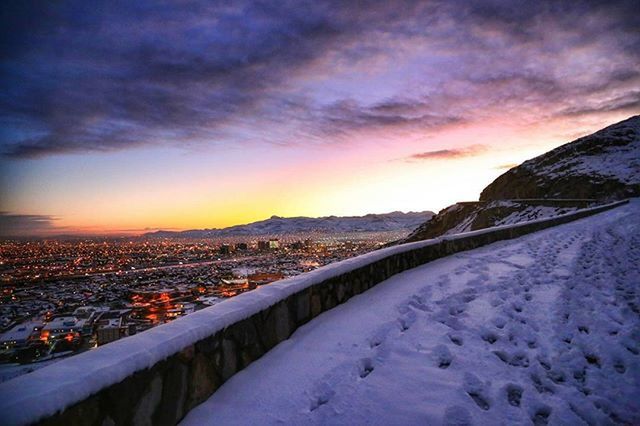 SNOW COVERED LANDSCAPE AT SUNSET