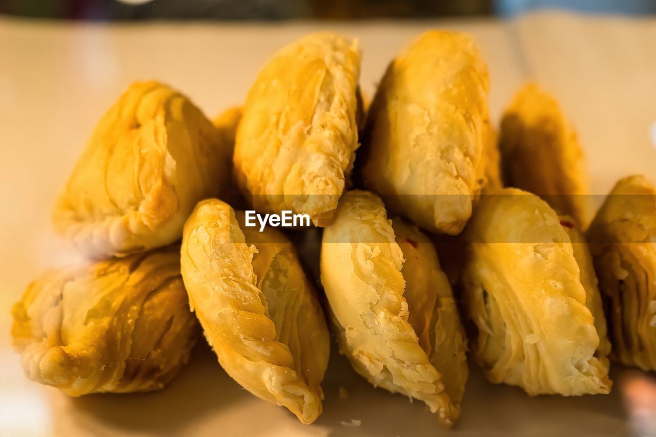 Curry puff pastry stuffed chicken and bean eat couple with tea cup