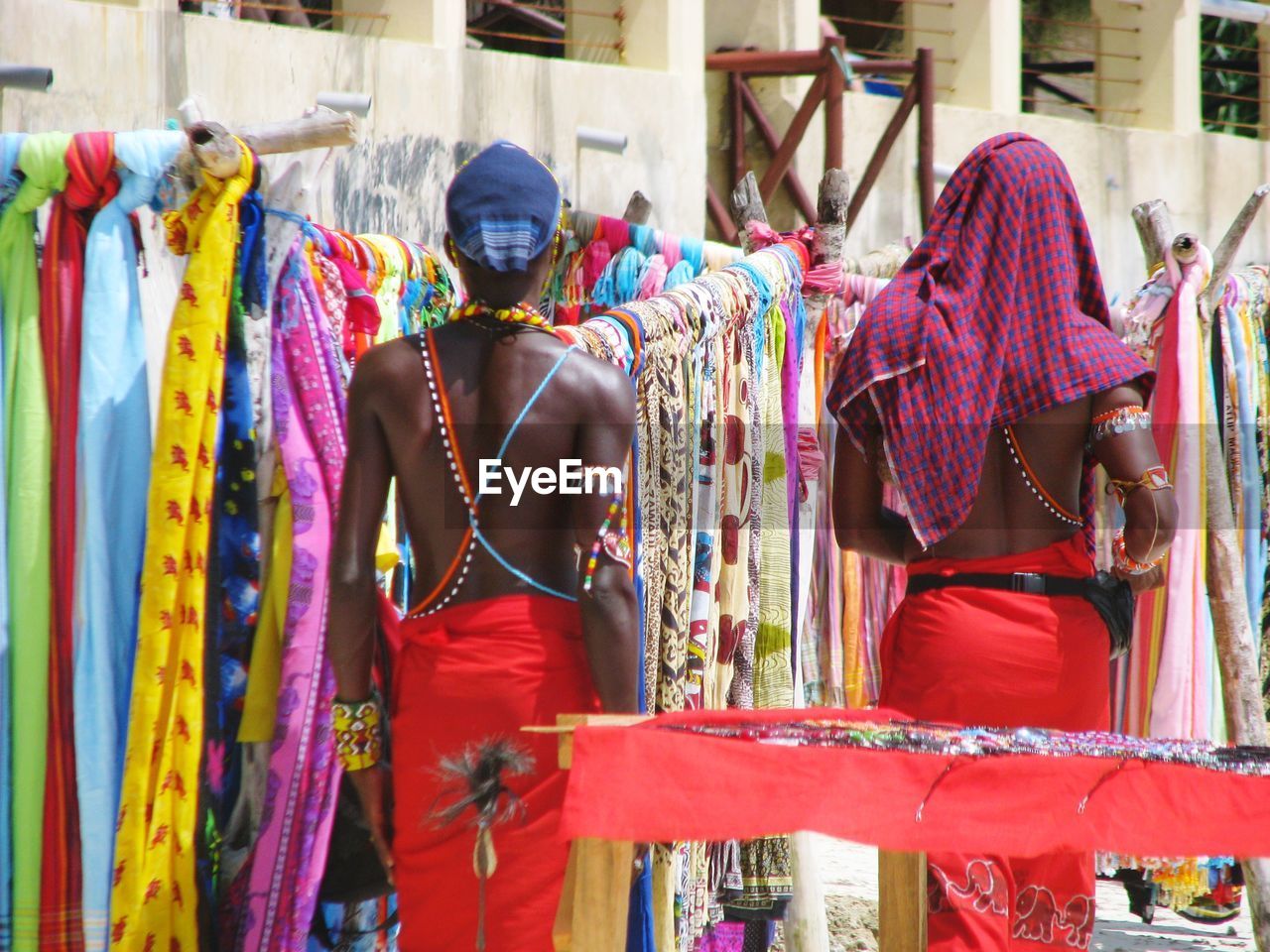 Rear view of men standing in market