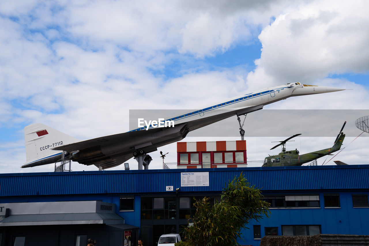 architecture, transport, built structure, building exterior, sky, cloud, vehicle, transportation, nature, aviation, mode of transportation, airplane, business, aircraft, day, city, building, outdoors, no people, stadium, business finance and industry