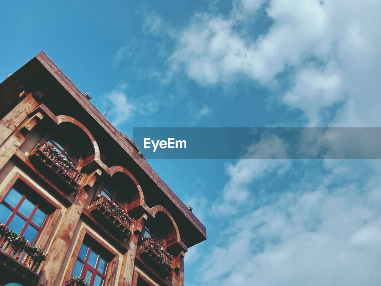 Low angle view of building against cloudy sky