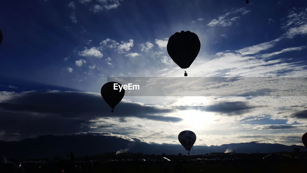 Silhouette hot air balloon against sky