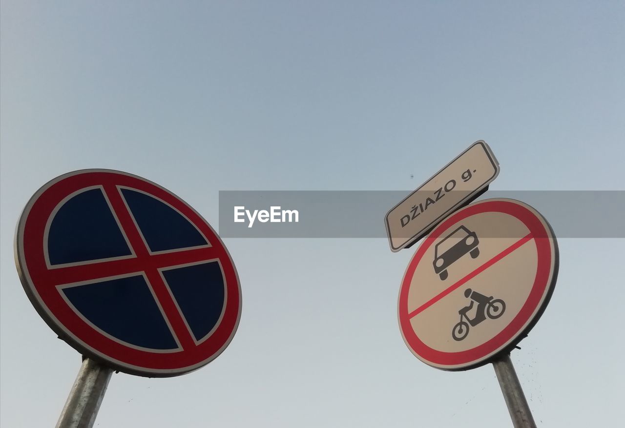 LOW ANGLE VIEW OF ROAD SIGNS AGAINST CLEAR SKY