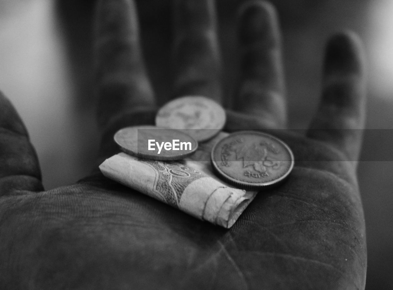 A worker's hand with some money