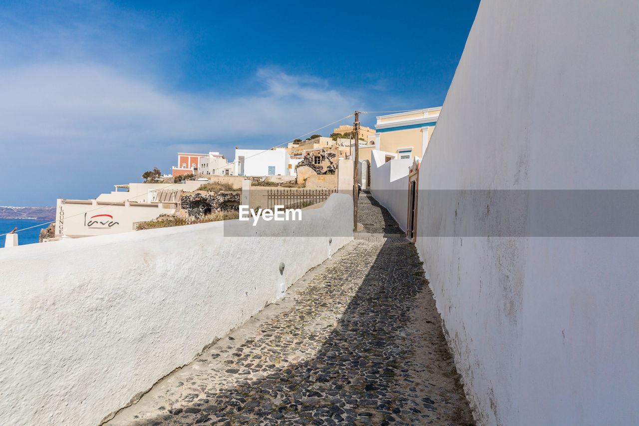 FOOTPATH BY BUILDINGS AGAINST SKY