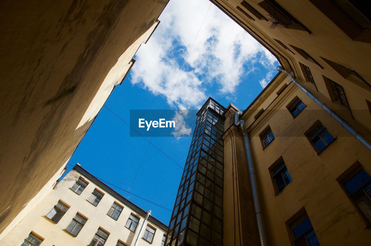 Low angle view of building against cloudy sky