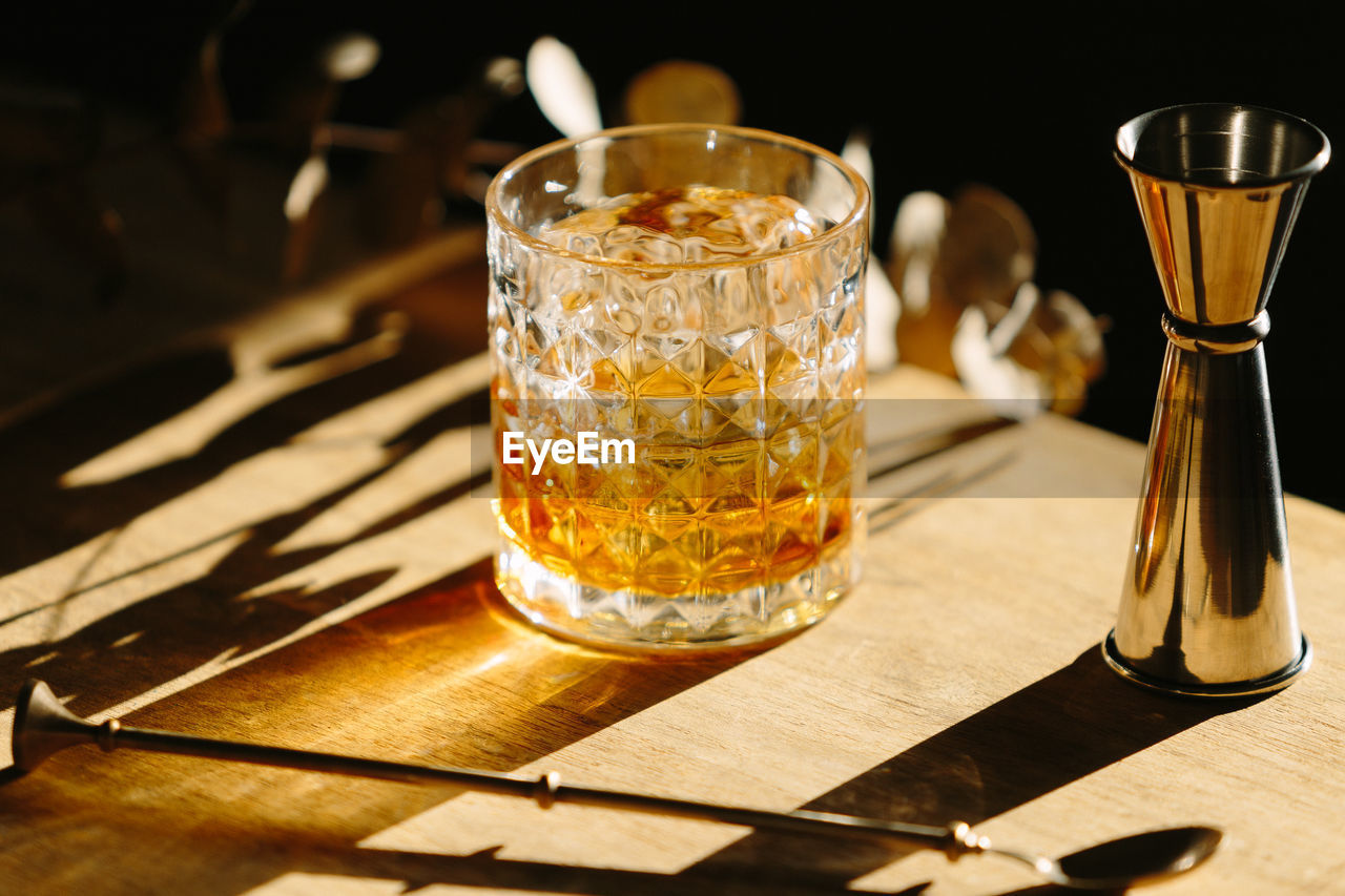 Close-up of glass with bourbon whiskey on table