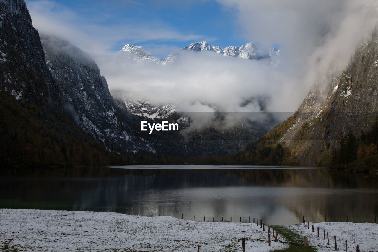 Scenic view of lake and mountains against sky