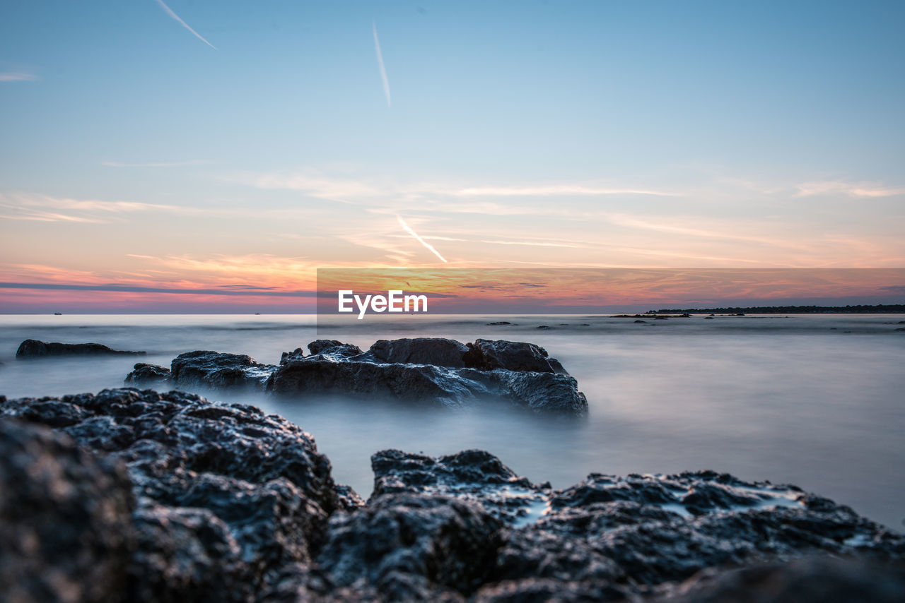 Scenic view of sea against sky during sunset