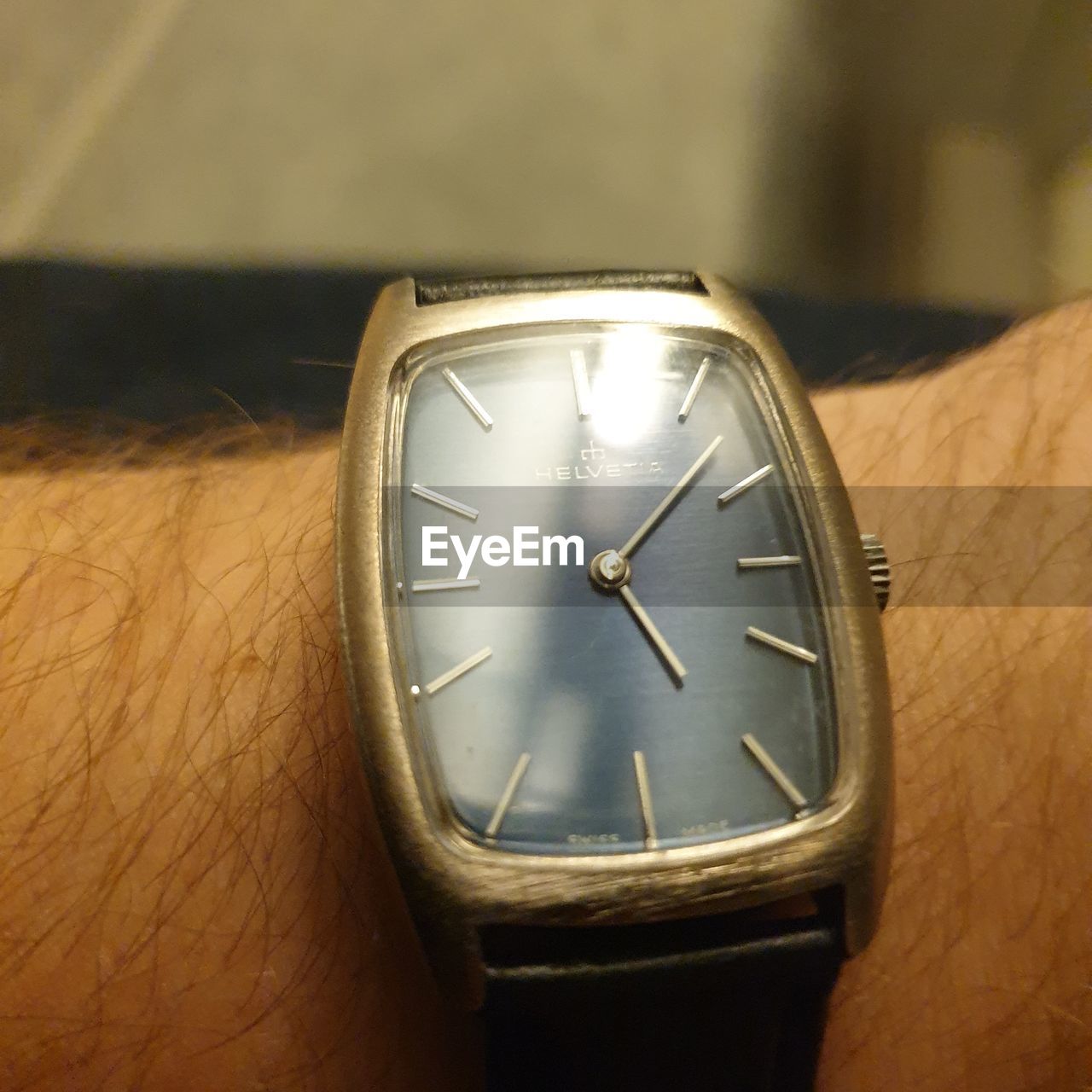 CLOSE-UP OF HUMAN HAND ON CLOCK