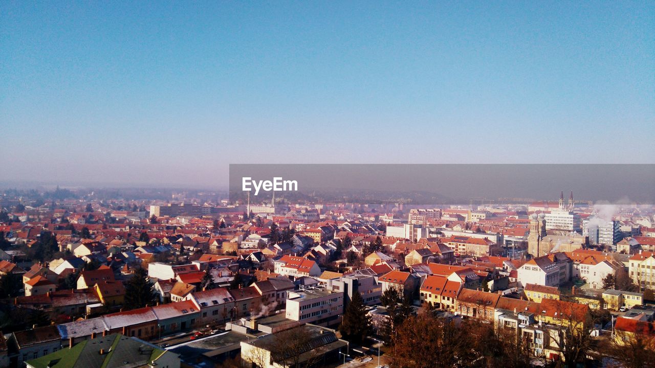 Cityscape against clear blue sky