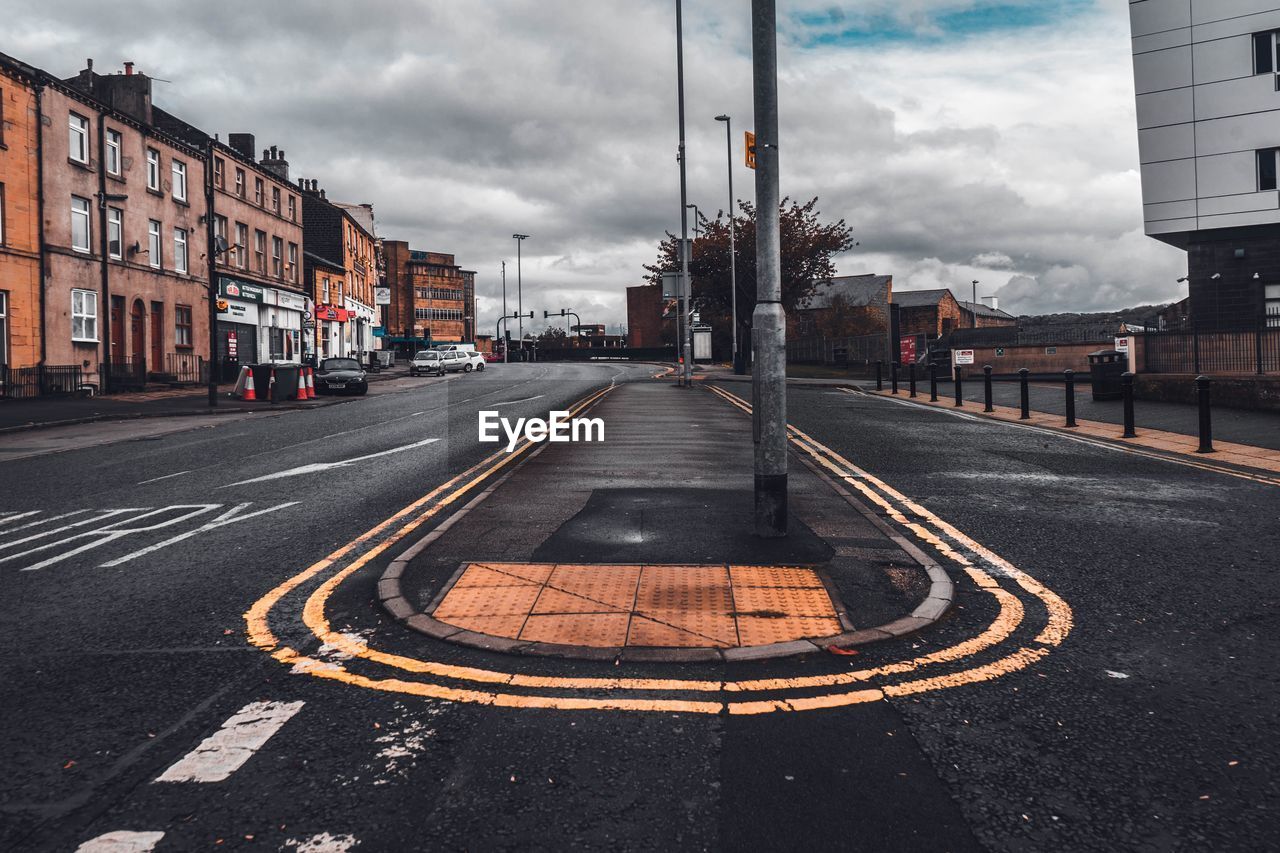 Roads in city against cloudy sky