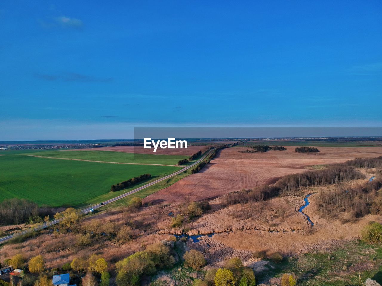 Scenic view of landscape against blue sky