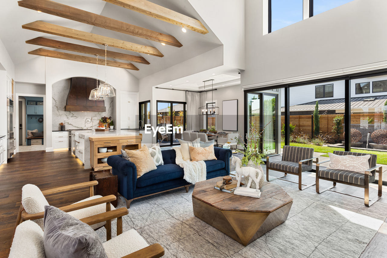 Living room and kitchen interior in new luxury home with large windows